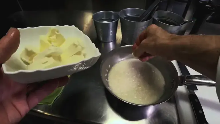 adding butter to risotto
