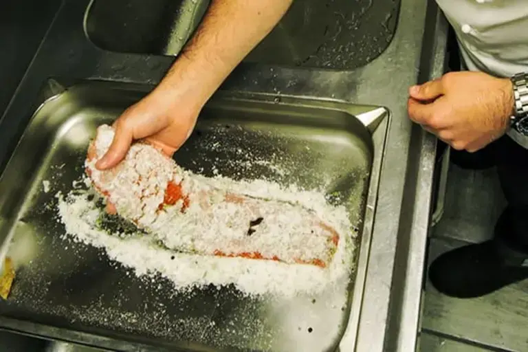 trout fillets in a tray by Callan Austin