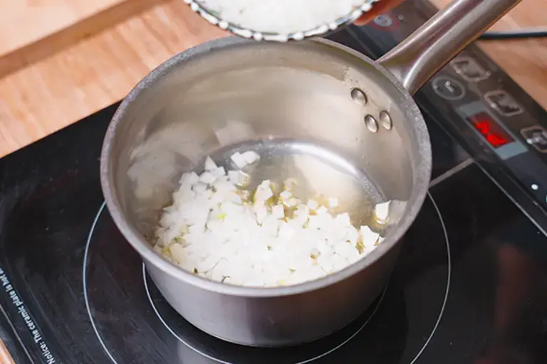 Frying the chopped onion.