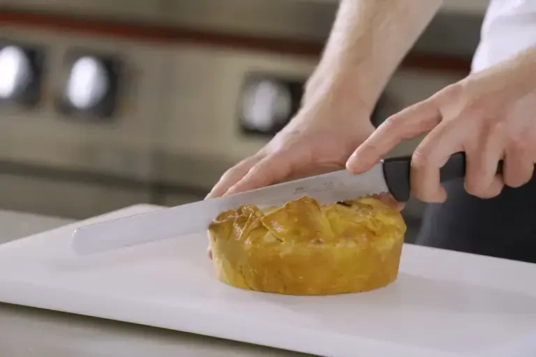 A pie being cut with a knife.