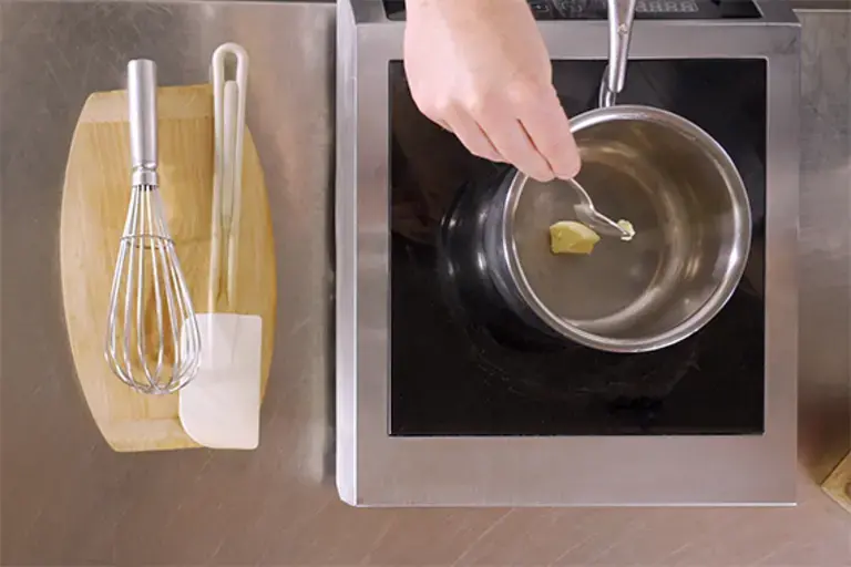 A roux being stirred in a pan.