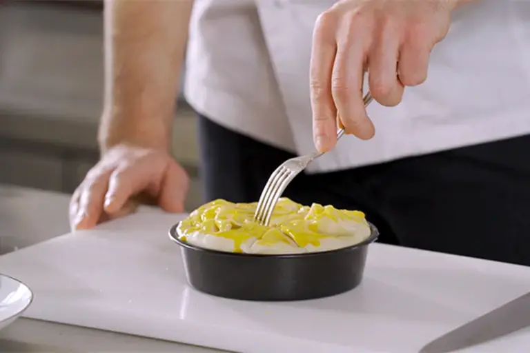 Holes being poked in a pie top with a fork.