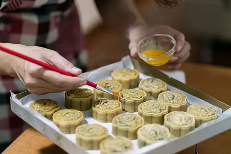 Brushing mooncakes with eggwash