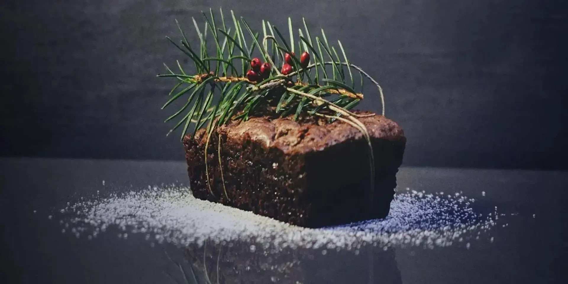A Christmas cake with a pine twig decoration.