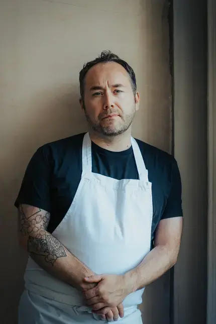Chef Stuart Ralston in an apron.