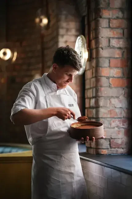 Chef Tom Barnes serving tiramisu.