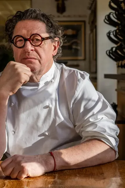 Chef Marco Pierre White in chef's whites and spectacles.