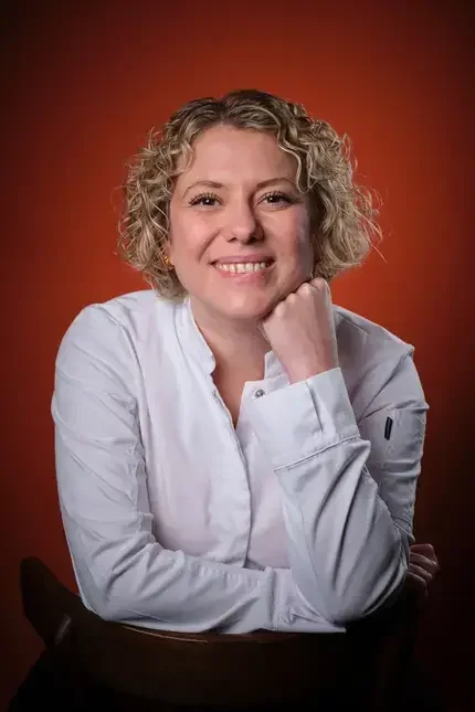Chef Sally Abé in a white shirt.