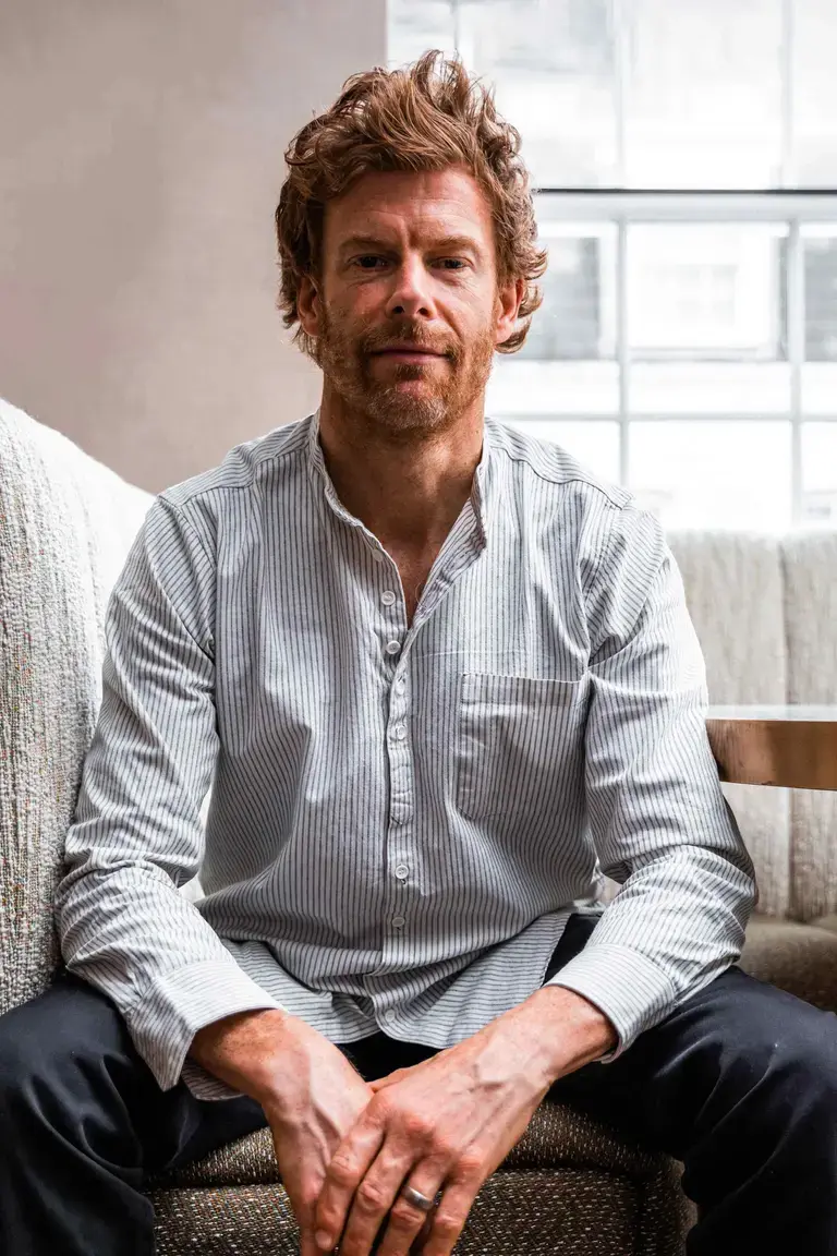 Chef Tom Aikens, seated in casual clothes.