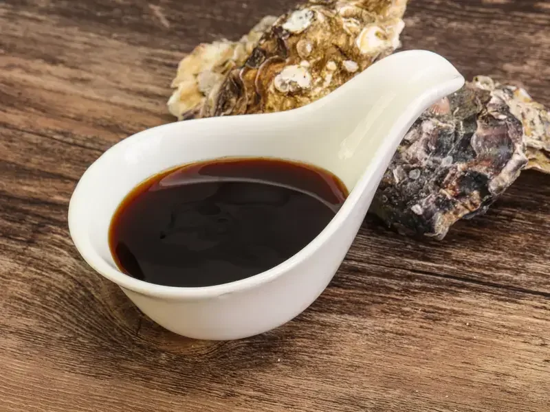 Oyster sauce and two oyster shells.