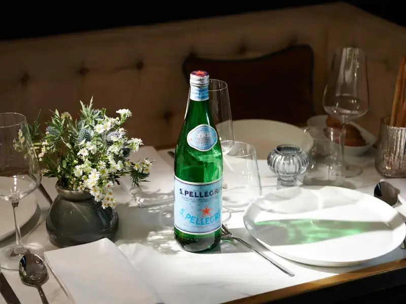 A bottle of S.Pellegrino on a table