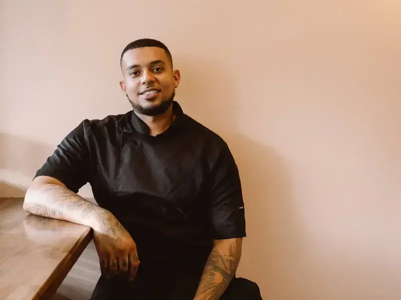 Chef Nathaniel Mortley in black chef's clothes.