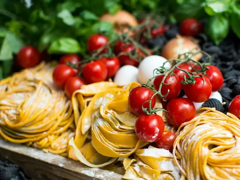 Raw fresh pasta and cherry tomatoes.