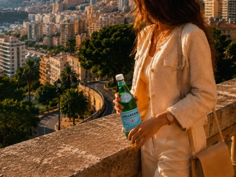 Woman holding a bottle of S.Pellegrino in Monte Carlo.