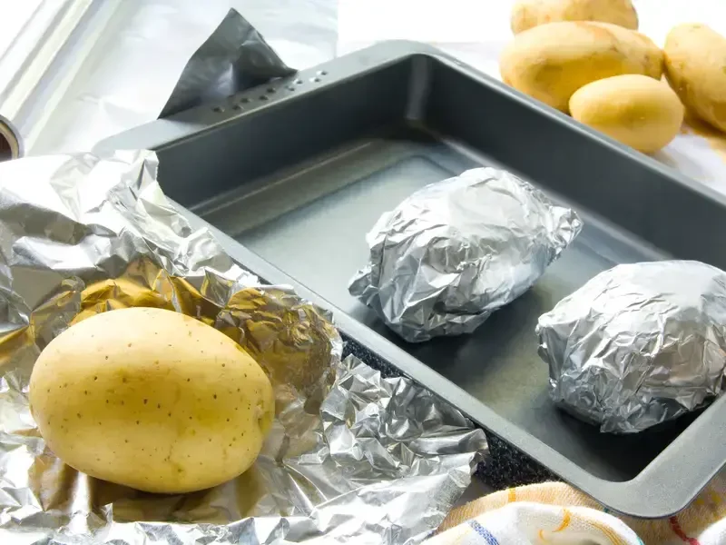 Baked potatoes wrapped in aluminium foil