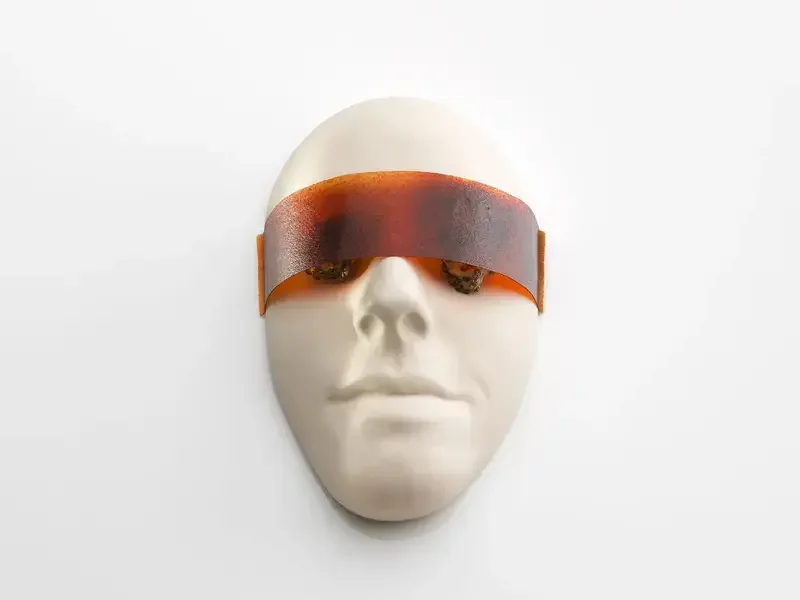 A white plastercast face with visor