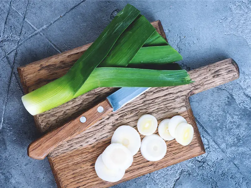Leeks on a chopping board.