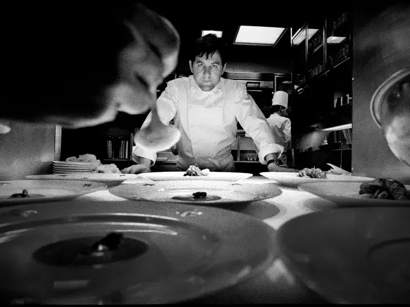 chef Charlie Trotter standing at the pass in a kitchen