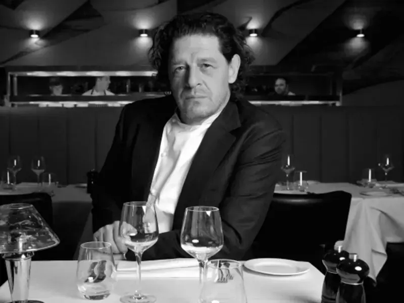 Marco Pierre White sat at a restaurant table.