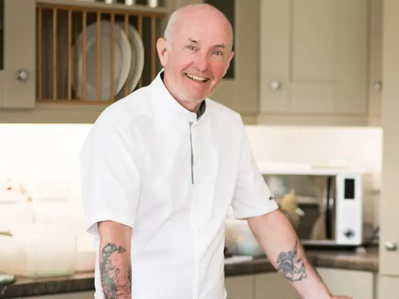 A smiling male chef. h