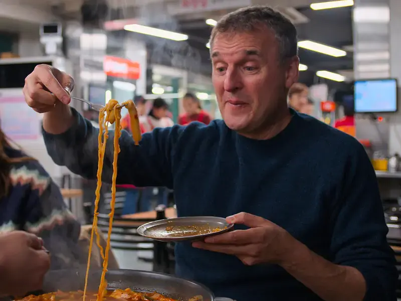 Phil Rosenthal eating noodles