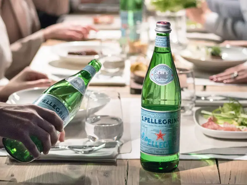 table of people with S. Pellegrino water bottles