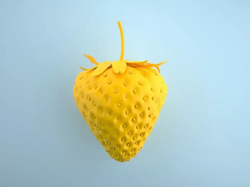 a yellow strawberry against a blue background