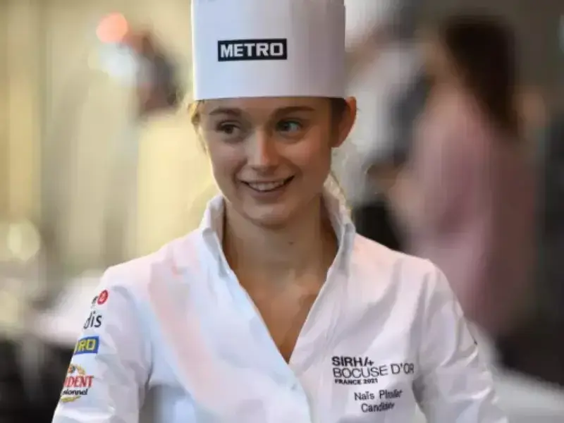 A young female chef in whites.