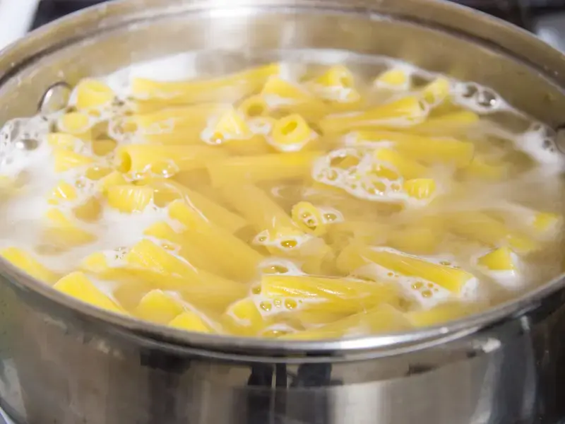 pasta cooking in a pan of boiling water