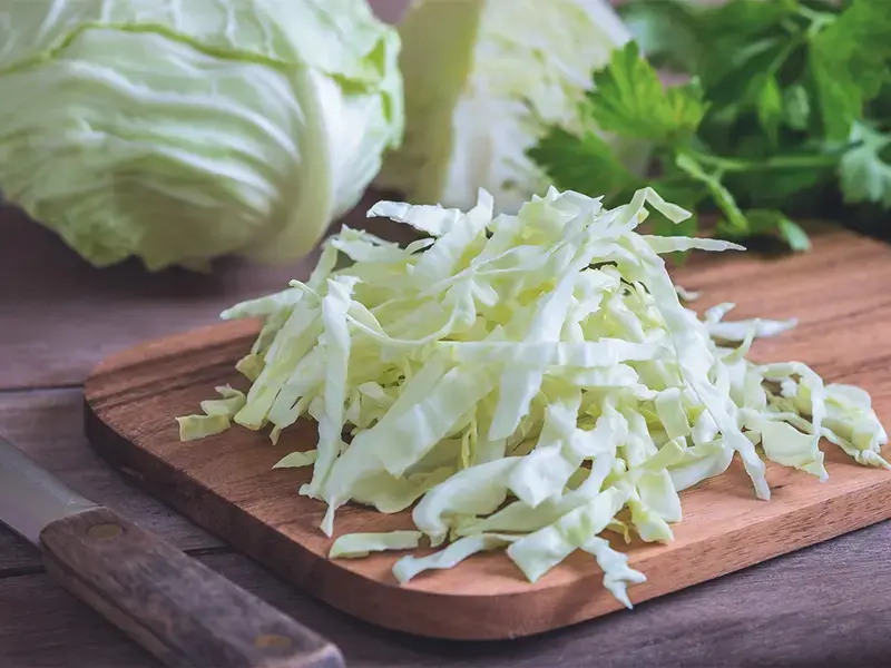 Cut cabbage on a chopping board.