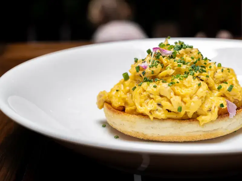 Creamy scrambled eggs on a muffin.