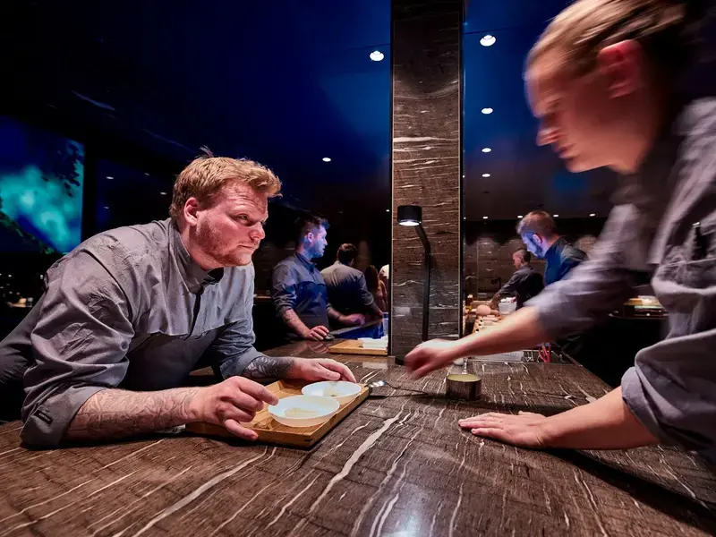 Head Chef Rasmus Munk plating the impression King Crab together with chef Rasmus Bermann.