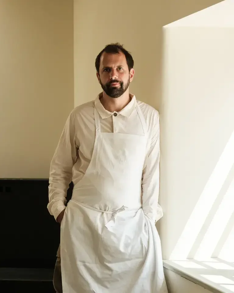 Chef Merlin Labron-Johnson standing next to a window.