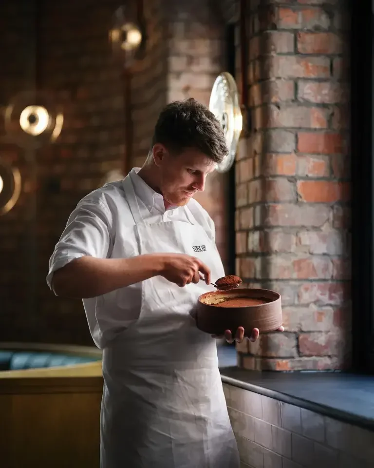 Chef Tom Barnes serving tiramisu.