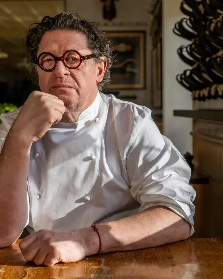 Chef Marco Pierre White in chef's whites and spectacles.