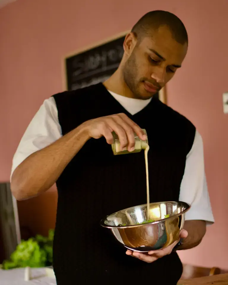 Joseph Denison Carey pouring a liquid into a mixing bowl.
