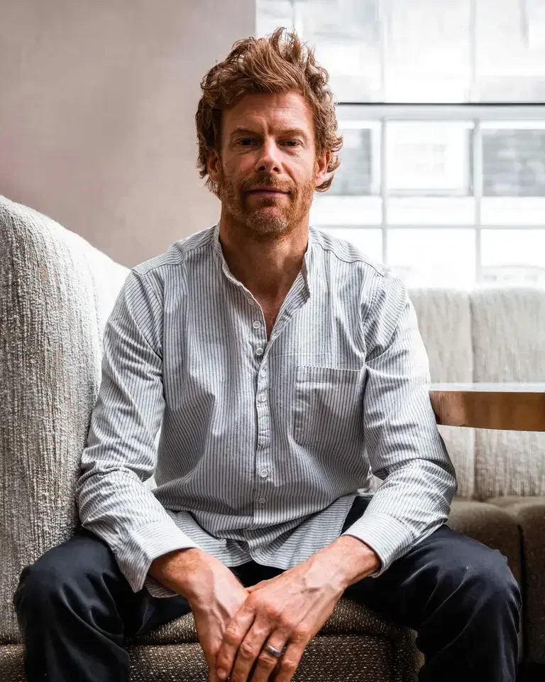 Chef Tom Aikens, seated in casual clothes.