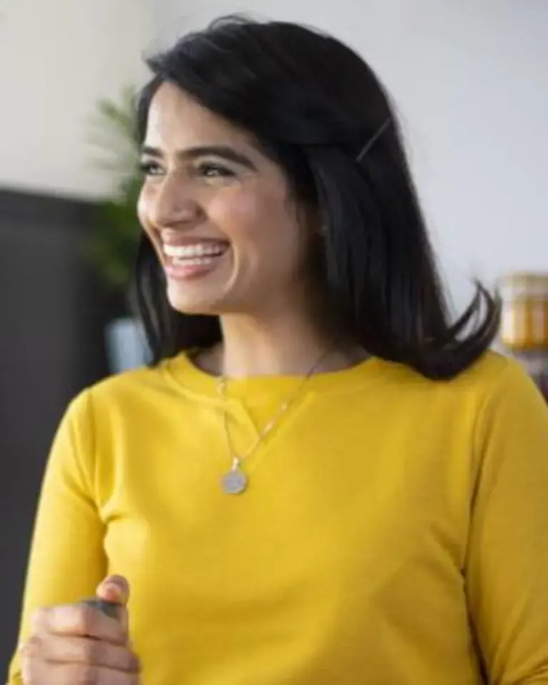 Chef Monica Haldar in a yellow sweater.
