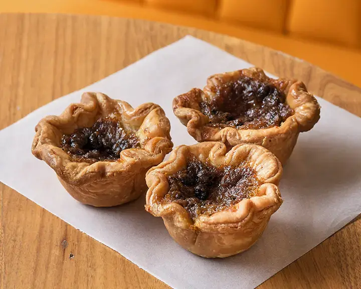 Butter tarts by Jonny Lake, on a table.