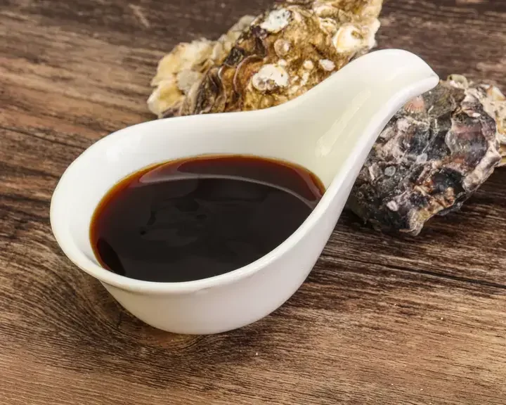 Oyster sauce and two oyster shells.