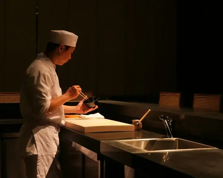 A sushi chef in the kitchen.