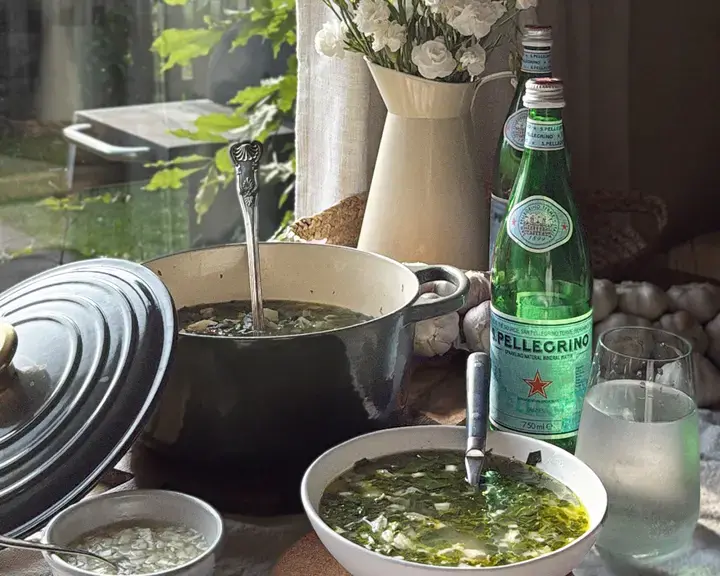 Chicken and Swiss chard soup and a bottle of S.Pellegrino.