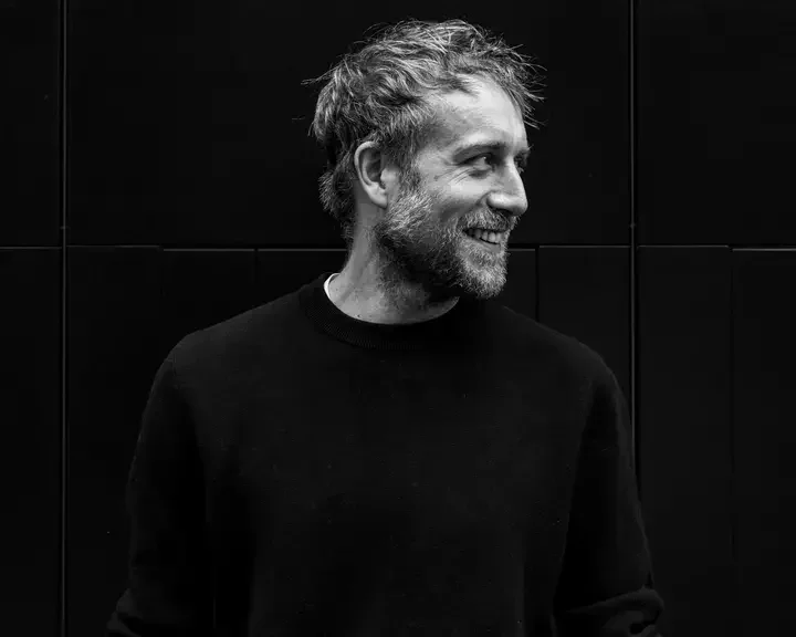 Chef Rob Roy Cameron looking sideways in a dark sweatshirt.