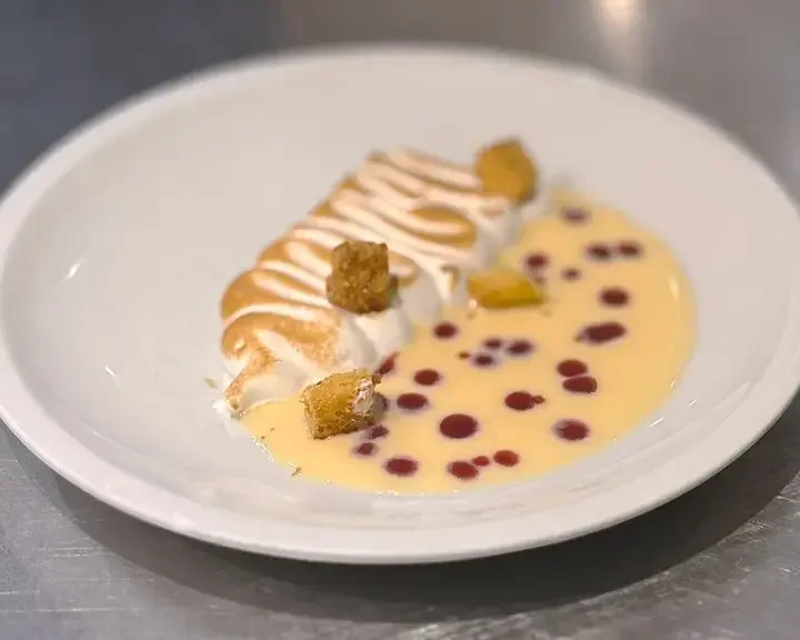 Meringue, pandoro and red berry coulis.