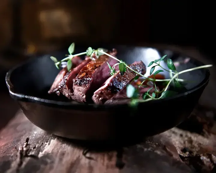Venison dish in a dark bowl.