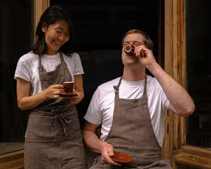 Kyu Jeon and Duncan Robertson drinking coffee.