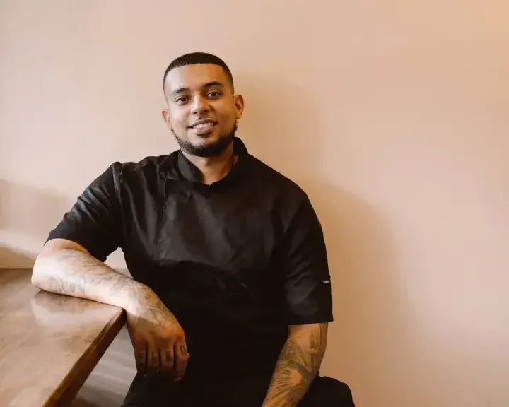 Chef Nathaniel Mortley in black chef's clothes.