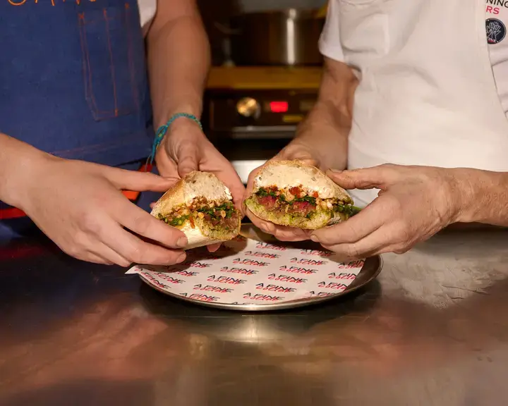 Two chefs holding the Fine Collab Sandwich in London.