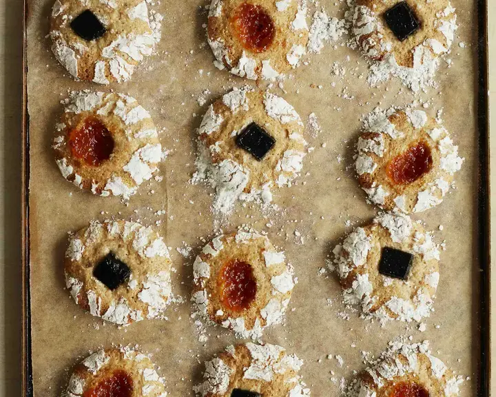 Hazlenut and jam biscuits by Twelve Triangles on a baking tray.