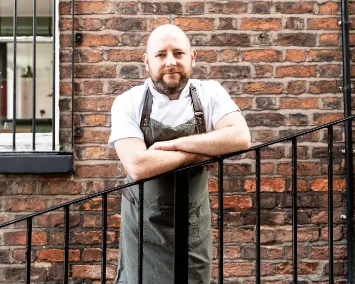 Chef Dan McGeorge leaning on a railing.
